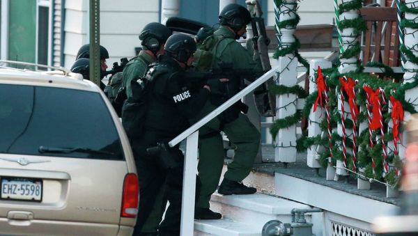 Police gather near a home, Monday, Dec. 15, 2014, in Pennsburg, Pa., where suspect Bradley William Stone is believed to have barricaded himself inside after shootings at multiple homes - Sputnik International