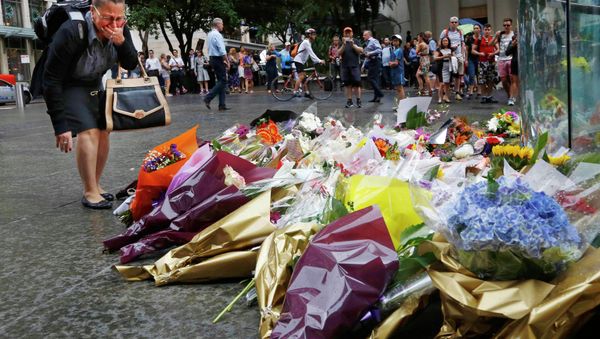A woman reacts after placing a floral tribute for those who died in the Sydney cafe siege, near the site of the incident, in Martin Place December 16, 2014 A woman reacts after placing a floral tribute for those who died in the Sydney cafe siege, near the site of the incident, in Martin Place December 16, 2014 - Sputnik International