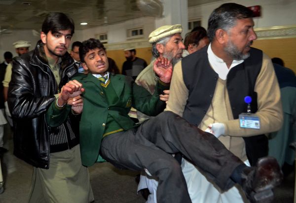 Pakistani volunteers carry a student injured in the shootout at a school under attack by Taliban gunmen, at a local hospital in Peshawar, Pakistan,Tuesday, Dec. 16, 2014 - Sputnik International