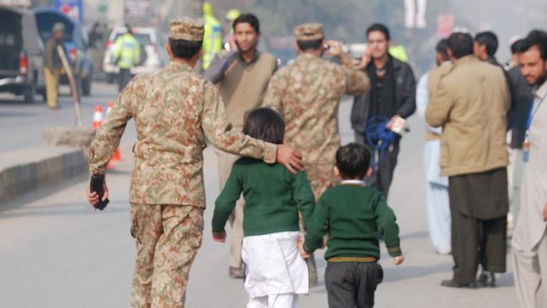 A soldier escorts schoolchildren after they were rescued from the Army Public School attacked by Taliban gunmen in Peshawar. A soldier escorts schoolchildren after they were rescued from the Army Public School attacked by Taliban gunmen in Peshawar. - Sputnik International