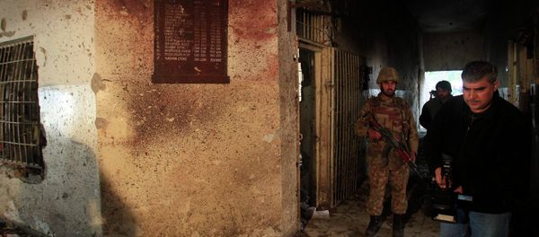 A local cameraman films in front of an army soldier at the Army Public School, which was attacked by Taliban gunmen, in Peshawar, December 17, 2014. A local cameraman films in front of an army soldier at the Army Public School, which was attacked by Taliban gunmen, in Peshawar, December 17, 2014. - Sputnik International