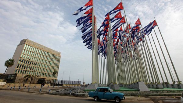 A car drives past the building of the the U.S. diplomatic mission in Cuba, The U.S. Interests Section, (USINT), in Havana, in this September 12, 2013 file picture. - Sputnik International