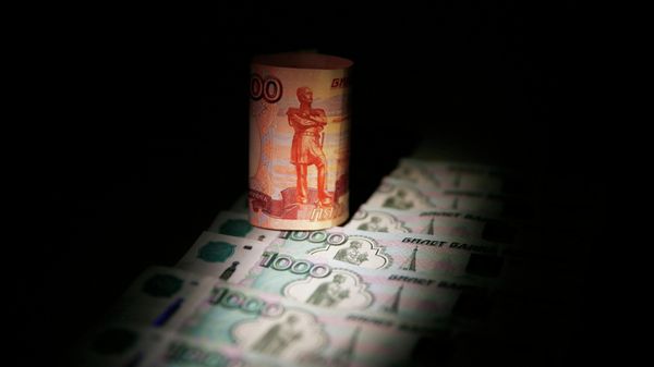 Russian rouble banknotes are seen in this file illustration picture taken in Moscow September 30, 2014. - Sputnik International