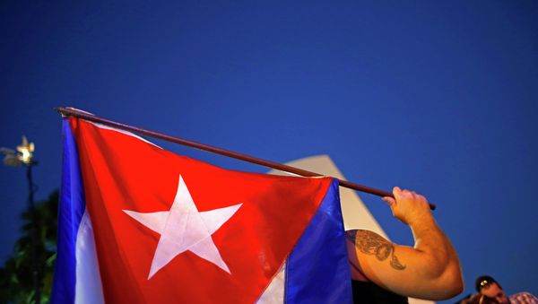 An anti-Castro Cuban exile holds a Cuban flag during a protest after the announcement of restoring diplomatic ties between Cuba and United States, at an area knows as 'Little Havana' in downtown Miami, Florida December 17, 2014. An anti-Castro Cuban exile holds a Cuban flag during a protest after the announcement of restoring diplomatic ties between Cuba and United States, at an area knows as 'Little Havana' in downtown Miami, Florida December 17, 2014. - Sputnik International