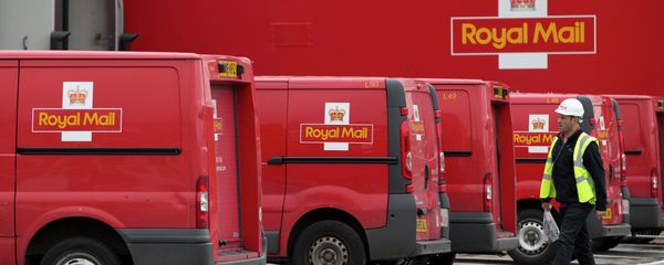 A post office worker walks by Royal Mail vans, at the London's latest sorting office Mount Pleasant. A post office worker walks by Royal Mail vans, at the London's latest sorting office Mount Pleasant. - Sputnik International
