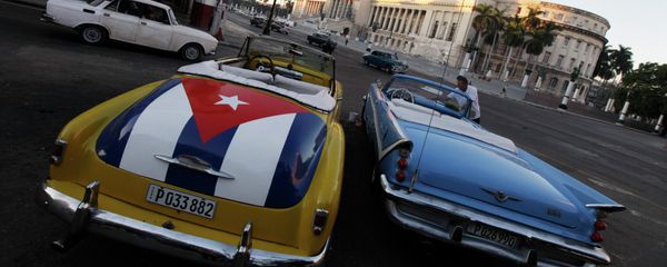 A car with a Cuban flag is parked near Cuban Capitol in Havana December 18, 2014. Cuban President Raul Castro hailed a landmark exchange of prisoners with the United States on Wednesday and praised U.S. President Barack Obama as the two countries agreed to normalize relations after more than five decades of hostility A car with a Cuban flag is parked near Cuban Capitol in Havana December 18, 2014. Cuban President Raul Castro hailed a landmark exchange of prisoners with the United States on Wednesday and praised U.S. President Barack Obama as the two countries agreed to normalize relations after more than five decades of hostility - Sputnik International