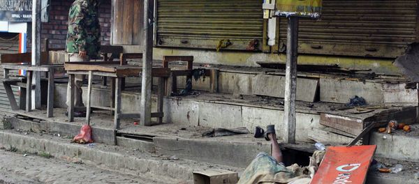 The body of a blast victim is seen as an Indian policeman stands at the site of an explosion in Imphal, the capital of Manipur state, India, Sunday, Dec. 21, 2014 The body of a blast victim is seen as an Indian policeman stands at the site of an explosion in Imphal, the capital of Manipur state, India, Sunday, Dec. 21, 2014 - Sputnik International