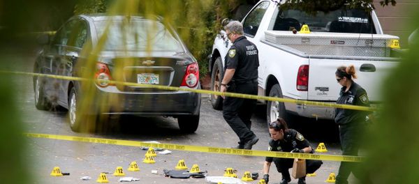 Forensic investigators at the scene where Tarpon Springs police officer Charles Kondek was shot and killed on Sunday morning. Forensic investigators at the scene where Tarpon Springs police officer Charles Kondek was shot and killed on Sunday morning. - Sputnik International
