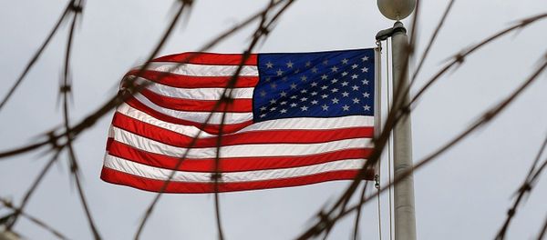 An American Flag is seen through razor wire at Camp VI in Camp Delta where detainees are housed at Naval Station Guantanamo Bay in Cuba An American Flag is seen through razor wire at Camp VI in Camp Delta where detainees are housed at Naval Station Guantanamo Bay in Cuba - Sputnik International