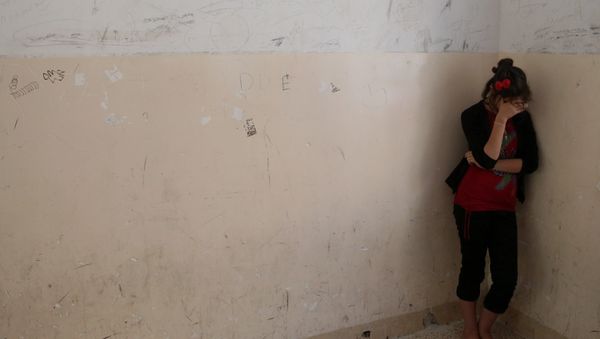 An Iraqi Yazidi woman gestures during the visit of Cardinal Fernando Filoni, the Pope Francis special envoy to Iraq, at a school that was turned into a shelter for displaced Christians and Yazids in Mangesh in northern Iraq - Sputnik International