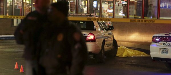 Police stand guard Wednesday, Dec. 24, 2014, following a shooting Tuesday at a gas station in Berkeley, Mo. - Sputnik International