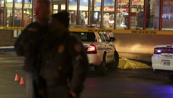 Police stand guard Wednesday, Dec. 24, 2014, following a shooting Tuesday at a gas station in Berkeley, Mo. - Sputnik International