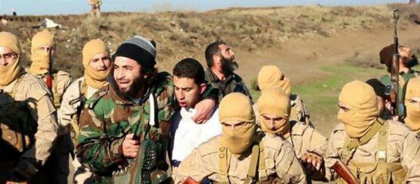 Мembers of the Islamic State group with the captured Jordanian pilot, center, wearing a white shirt, in Raqqa, Syria Мembers of the Islamic State group with the captured Jordanian pilot, center, wearing a white shirt, in Raqqa, Syria - Sputnik International