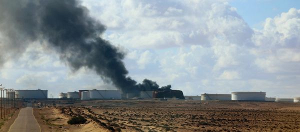 A violent skirmish between Libyan soldiers and Islamist militants on Thursday, December 25, in eastern Libya claimed the lives of 19, while an oil tanker was damaged by a rocket at the port of Al-Sidra during a separate clash A violent skirmish between Libyan soldiers and Islamist militants on Thursday, December 25, in eastern Libya claimed the lives of 19, while an oil tanker was damaged by a rocket at the port of Al-Sidra during a separate clash - Sputnik International