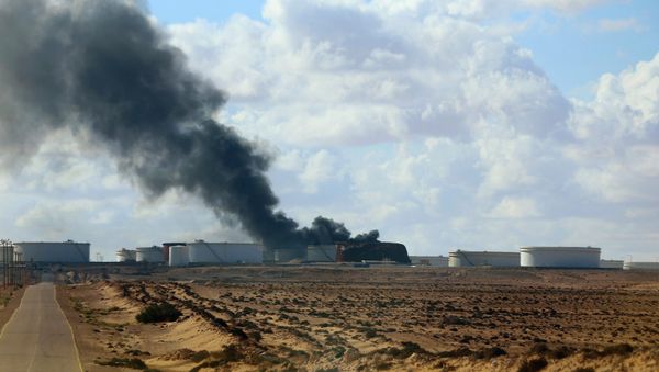 A violent skirmish between Libyan soldiers and Islamist militants on Thursday, December 25, in eastern Libya claimed the lives of 19, while an oil tanker was damaged by a rocket at the port of Al-Sidra during a separate clash A violent skirmish between Libyan soldiers and Islamist militants on Thursday, December 25, in eastern Libya claimed the lives of 19, while an oil tanker was damaged by a rocket at the port of Al-Sidra during a separate clash - Sputnik International