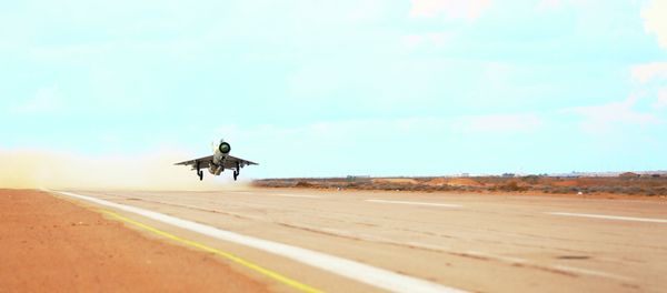 A MiG-21 fighter jet belonging to forces loyal to former general Khalifa Haftar takes off from a base on the outskirts of Al Sidra oil port, in Ras Lanuf - Sputnik International