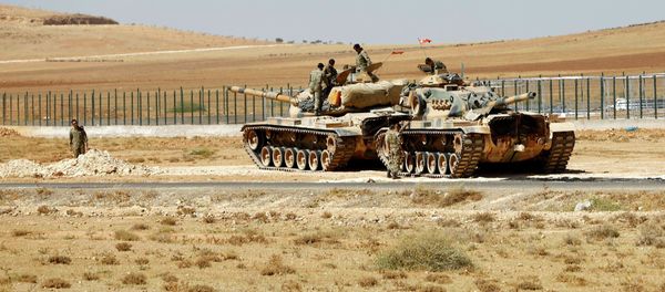 Turkish soldiers stand on top of tanks next to the Syrian-Trukish border fence (file photo) Turkish soldiers stand on top of tanks next to the Syrian-Trukish border fence (file photo) - Sputnik International