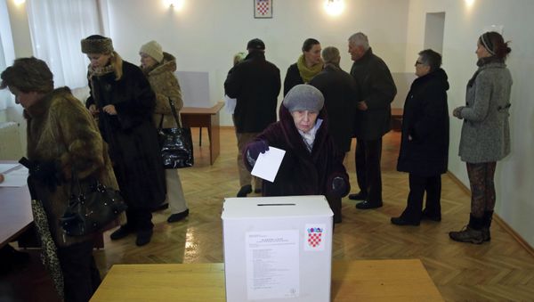 A woman casts her ballot at a polling station during the presidential election in Zagreb A woman casts her ballot at a polling station during the presidential election in Zagreb - Sputnik International