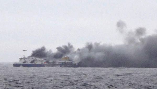 Smoke rises from the Italian-flagged Norman Atlantic after it caught fire in the Adriatic Sea Smoke rises from the Italian-flagged Norman Atlantic after it caught fire in the Adriatic Sea - Sputnik International