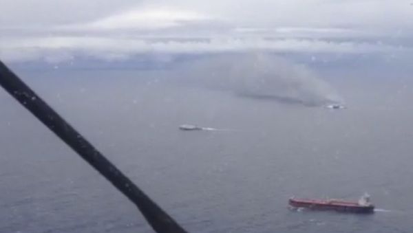 In this image taken from a video released by the Italian Air Force, smoke billows from the Italian-flagged Norman Atlantic, top right, after it caught fire in the Adriatic Sea, Sunday, Dec. 28, 2014. - Sputnik International