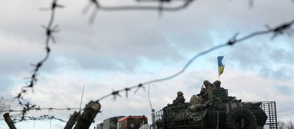 A Ukrainian military convoy is pictured through a barbed wire fence at a military base in the town of Kramatorsk, eastern Ukraine - Sputnik International
