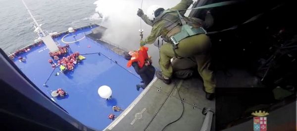 A person is lifted on an Italian Navy helicopter as the car ferry Norman Atlantic burns in waters off Greece December 28, 2014 in this handout video grab of the Italian Marina Militare A person is lifted on an Italian Navy helicopter as the car ferry Norman Atlantic burns in waters off Greece December 28, 2014 in this handout video grab of the Italian Marina Militare - Sputnik International
