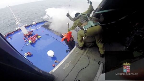 A person is lifted on an Italian Navy helicopter as the car ferry Norman Atlantic burns in waters off Greece December 28, 2014 in this handout video grab of the Italian Marina Militare - Sputnik International