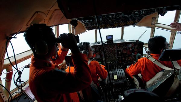 Airforce soldiers onboard a Hercules C130 stand monitor the Belitung Timur sea during search operations for AirAsia flight QZ8501 near Belitung island, December 29, 2014 Airforce soldiers onboard a Hercules C130 stand monitor the Belitung Timur sea during search operations for AirAsia flight QZ8501 near Belitung island, December 29, 2014 - Sputnik International