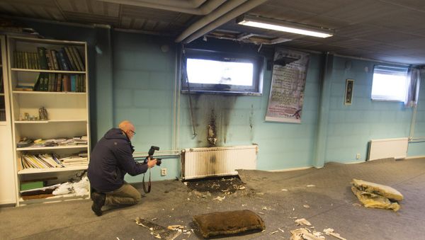 Police officers investigate a suspected arson attack after a fire in the basement of a mosque in the southern Swedish town of Eslov, Monday Dec. 29, 2014 - Sputnik International