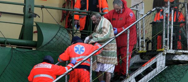 A wounded passenger is helped as he leaves from the Spirit of Piraeus cargo container ship after the car ferry Norman Atlantic caught fire in waters off Greece A wounded passenger is helped as he leaves from the Spirit of Piraeus cargo container ship after the car ferry Norman Atlantic caught fire in waters off Greece - Sputnik International
