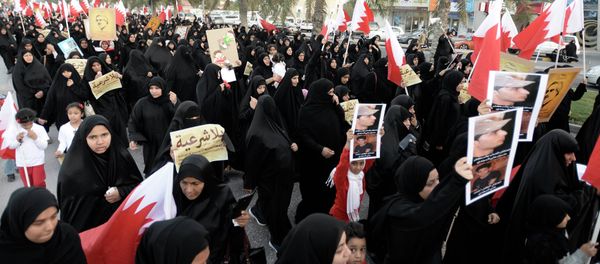 Protesters holding pictures of Al Waad President Ebrahim Shareef march during an anti-government rally organised by Bahrain's main opposition party, Al Wefaq in Budaiya west of Manama, December 26, 2014 Protesters holding pictures of Al Waad President Ebrahim Shareef march during an anti-government rally organised by Bahrain's main opposition party, Al Wefaq in Budaiya west of Manama, December 26, 2014 - Sputnik International