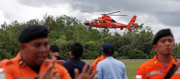 An Indonesian Search and Rescue helicopter carrying the bodies of two AirAsia passengers recovered from the sea prepares to land at the airport in Pangkalan Bun, Central Kalimantan, December 31, 2014 An Indonesian Search and Rescue helicopter carrying the bodies of two AirAsia passengers recovered from the sea prepares to land at the airport in Pangkalan Bun, Central Kalimantan, December 31, 2014 - Sputnik International