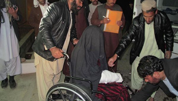 A wounded Afghan woman is brought to the hospital in Helmand province early on January 1, 2015 A wounded Afghan woman is brought to the hospital in Helmand province early on January 1, 2015 - Sputnik International