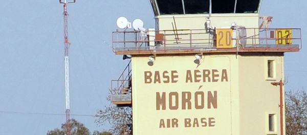 Firefighters stand in front of an air traffic control tower at the Moron de la Frontera air base near Sevilla - Sputnik International
