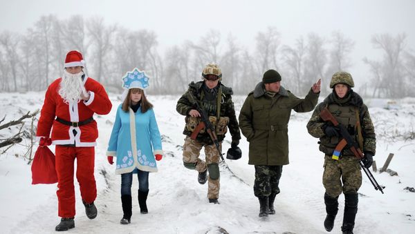 Local residents dressed as Father Frost, an equivalent of Santa Claus, and his granddaughter Snegurochka (Snow-Maiden), walk with servicemen as they visit check points of the Ukrainian army and self-defence units to congratulate the military with the coming of a New Year, near Lysychansk, Luhansk region, January 2, 2015. Local residents dressed as Father Frost, an equivalent of Santa Claus, and his granddaughter Snegurochka (Snow-Maiden), walk with servicemen as they visit check points of the Ukrainian army and self-defence units to congratulate the military with the coming of a New Year, near Lysychansk, Luhansk region, January 2, 2015. - Sputnik International