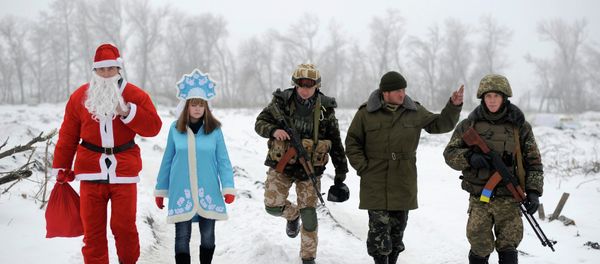 Local residents dressed as Father Frost, an equivalent of Santa Claus, and his granddaughter Snegurochka (Snow-Maiden), walk with servicemen as they visit check points of the Ukrainian army and self-defence units to congratulate the military with the coming of a New Year, near Lysychansk, Luhansk region, January 2, 2015. Local residents dressed as Father Frost, an equivalent of Santa Claus, and his granddaughter Snegurochka (Snow-Maiden), walk with servicemen as they visit check points of the Ukrainian army and self-defence units to congratulate the military with the coming of a New Year, near Lysychansk, Luhansk region, January 2, 2015. - Sputnik International