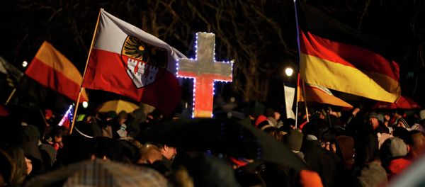 Participants take part in a demonstration called by anti-immigration group PEGIDA - Sputnik International