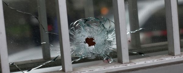 A bullet impact is seen in a window of a building next to the French satirical newspaper Charlie Hebdo's office in Paris. Wednesday, January 7, 2015. A bullet impact is seen in a window of a building next to the French satirical newspaper Charlie Hebdo's office in Paris. Wednesday, January 7, 2015. - Sputnik International