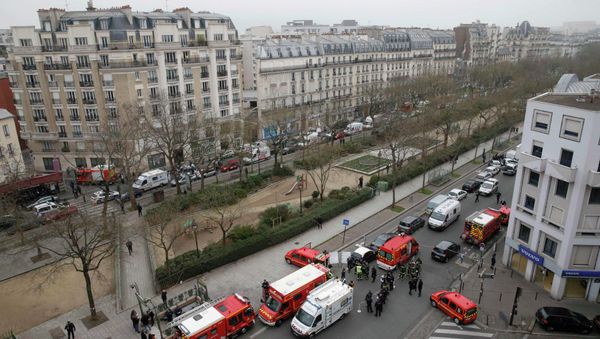 Police and rescue forces are seen near the scene after a shooting at the Paris offices of Charlie Hebdo, a satirical newspaper, January 7, 2015 - Sputnik International