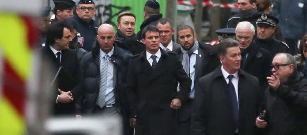 French Prime Minister Manuel Valls, front centre, walks with aids, outside the French satirical newspaper Charlie Hebdo's office, in Paris French Prime Minister Manuel Valls, front centre, walks with aids, outside the French satirical newspaper Charlie Hebdo's office, in Paris - Sputnik International