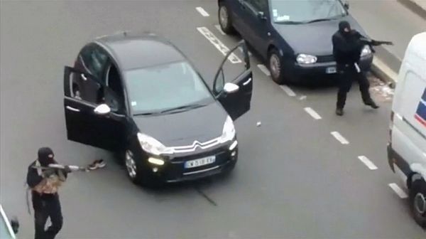 Gunmen flee the offices of French satirical newspaper Charlie Hebdo in Paris, in this still image taken from amateur video shot on January 7, 2015, and obtained by Reuters - Sputnik International