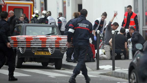 An injured person is treated by nursing staff outside the French satirical newspaper Charlie Hebdo's office, in Paris, Wednesday, Jan. 7, 2015 An injured person is treated by nursing staff outside the French satirical newspaper Charlie Hebdo's office, in Paris, Wednesday, Jan. 7, 2015 - Sputnik International