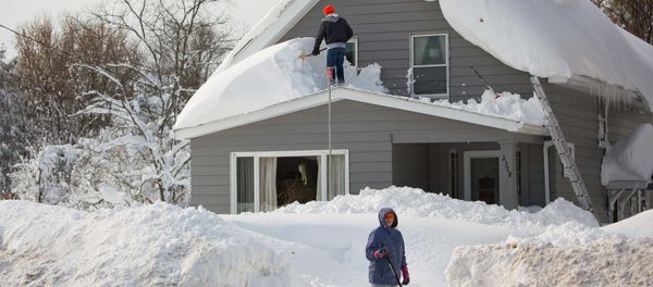 A man clears snow from his roof in the town of Cheektowaga near Buffalo, New York, November 19, 2014 - Sputnik International