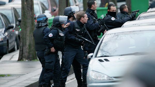 Police stand with their weapons drawn as they surround a bank during an attempted robbery in Paris, near Porte de Saint-Mande, on January 9, 2015 - Sputnik International
