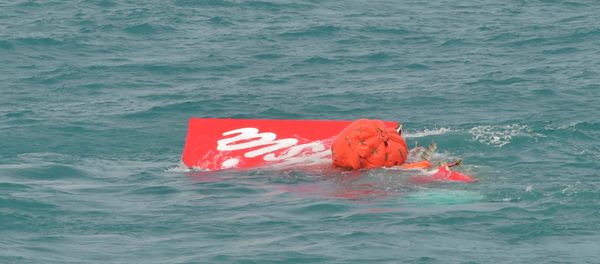 Part of the tail of AirAsia QZ8501 floats on the surface after being lifted as Indonesian navy divers conduct search operations for the black box flight recorders and passengers and crew of the aircraft, in the Java Sea January 10, 2015. Part of the tail of AirAsia QZ8501 floats on the surface after being lifted as Indonesian navy divers conduct search operations for the black box flight recorders and passengers and crew of the aircraft, in the Java Sea January 10, 2015. - Sputnik International