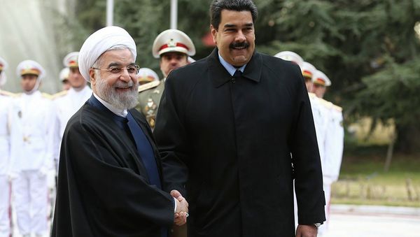 In this photo released by the official website of the office of the Iranian Presidency, Venezuelan President Nicolas Maduro, right, shakes hands with his Iranian counterpart Hassan Rouhani during his official welcoming ceremony at the Saadabad Palace in Tehran, Iran, Saturday, Jan. 10, 2015. In this photo released by the official website of the office of the Iranian Presidency, Venezuelan President Nicolas Maduro, right, shakes hands with his Iranian counterpart Hassan Rouhani during his official welcoming ceremony at the Saadabad Palace in Tehran, Iran, Saturday, Jan. 10, 2015. - Sputnik International