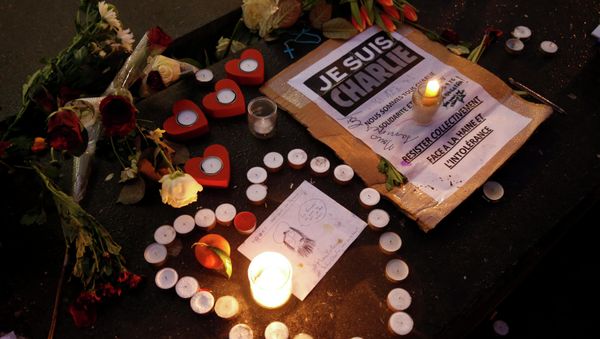 Candles form a heart, near a placard with the message, I am Charlie as people continue to pay tribute to the shooting victims on Wednesday at the satirical weekly Charlie Hebdo, at the Republique square in Paris - Sputnik International
