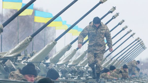 A Ukrainian serviceman walks on armoured personnel carriers (APC) - Sputnik International