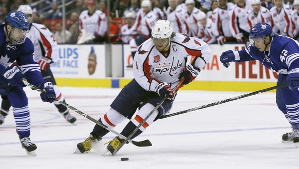 Washington Capitals forward Alex Ovechkin (8) carries the puck past Toronto Maple Leafs forward James van Riemsdyk (left) and forward Tyler Bozak (right) during the first period at the Air Canada Centre. - Sputnik International
