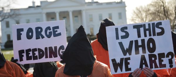 Hooded protestors, some holding placards, take part in a demonstration against the Guantanamo Bay detention facility utside of the White House in Washington Hooded protestors, some holding placards, take part in a demonstration against the Guantanamo Bay detention facility utside of the White House in Washington - Sputnik International